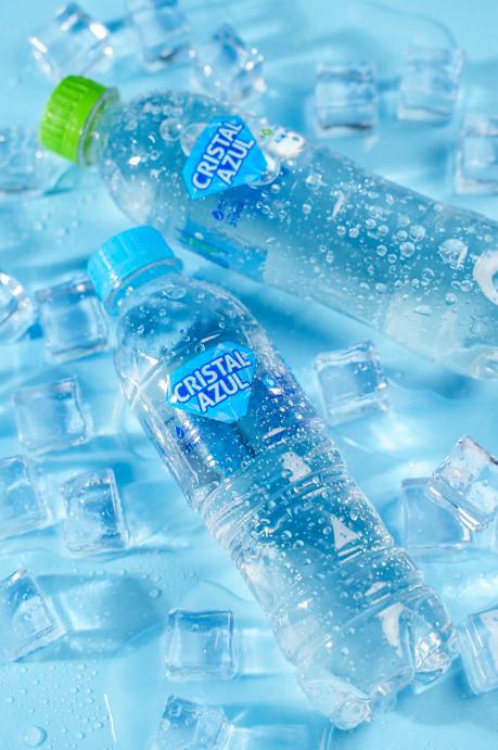 Garrafas de Cristal Azul com e sem gás entre cubos de gelo